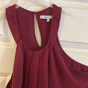 Maroon sleeveless top.